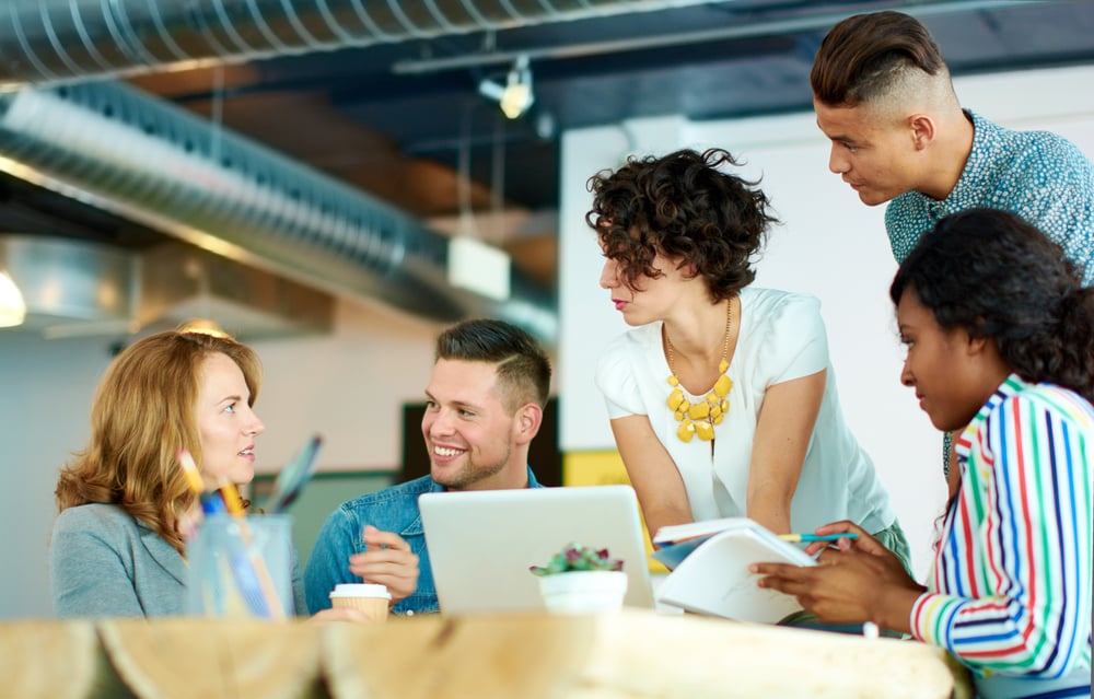 Candid image of a group with succesful business people caught in an animated brainstorming meeting Candid image of a group with succesful business people caught in an animated brainstorming meeting